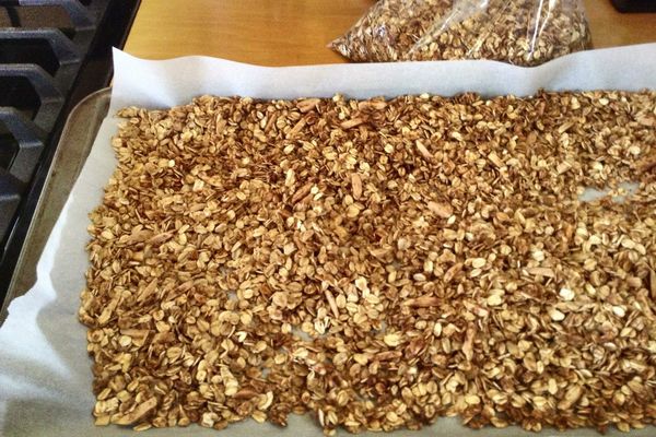 Freshly baked homemade granola spread on a baking sheet