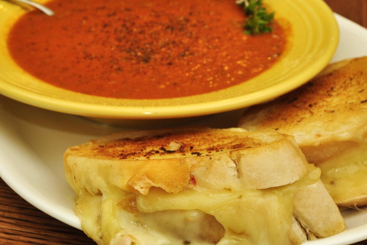 Bowl of tomato soup served with a grilled cheese sandwich