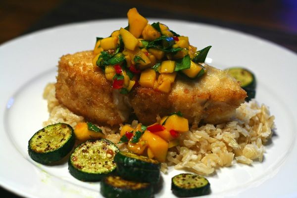White fish fillet topped with mango salsa over rice